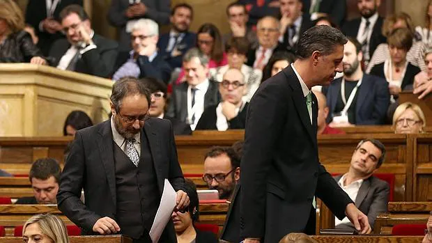 Albiol pasa junto a Antonio Baños en el Parlament