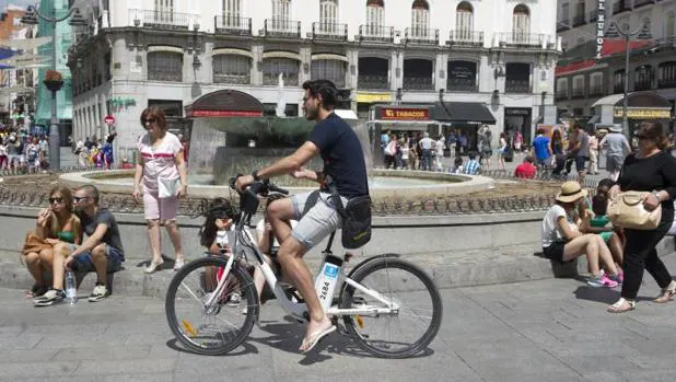 Un ciclista transita por el centro de Madrid con un BiciMad