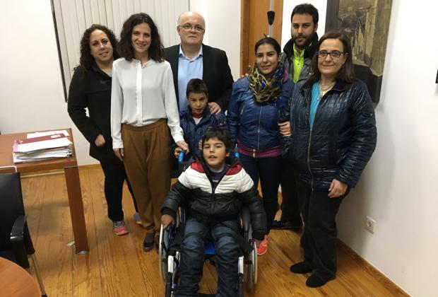 El niño de ocho años posa con su silla de ruedas