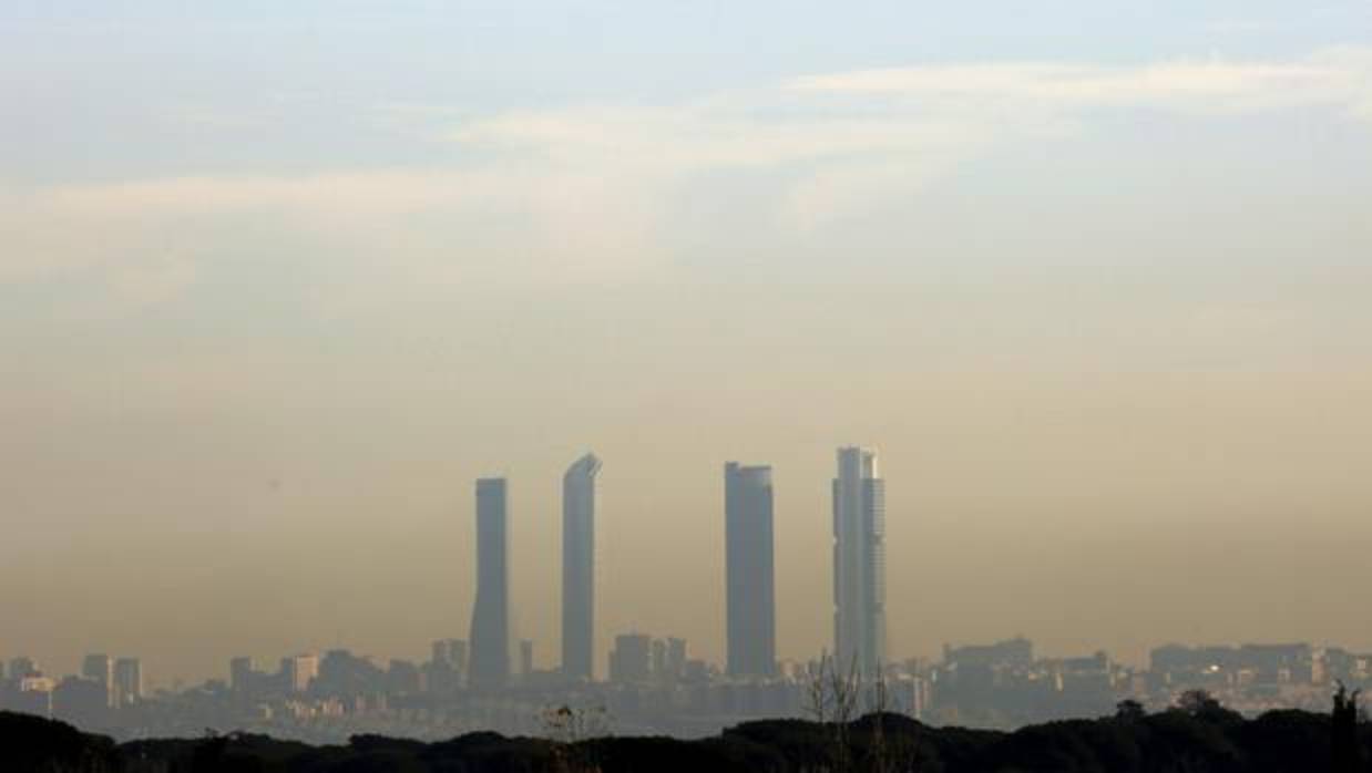 Nube de polución con las Cuatro Torres de fondo en Madrid