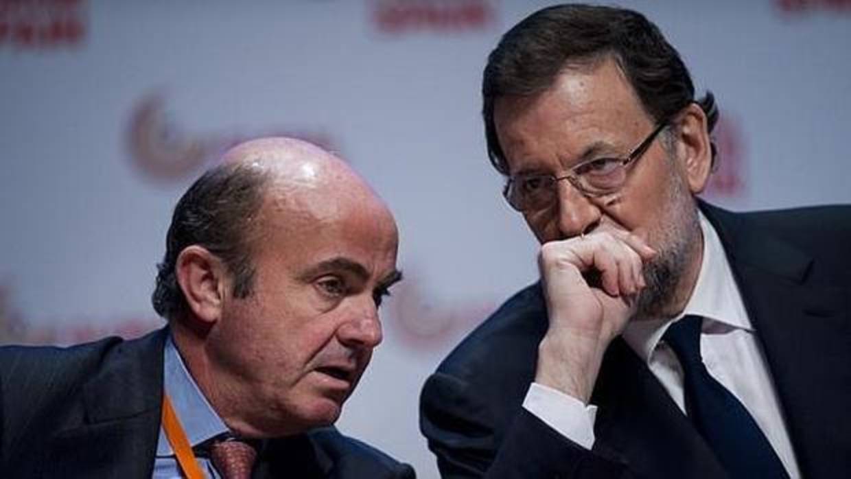 Luis de Guindos y Mariano Rajoy