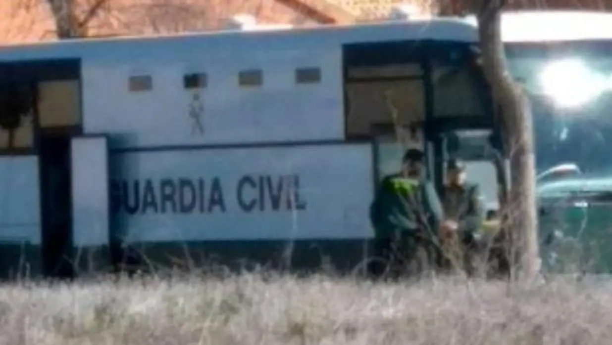 Dos agentes custodian este miércoles un autobús de la Guardia Civil en Burguillos