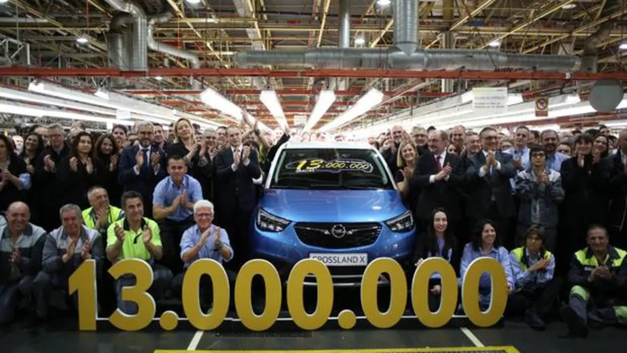 Foto de familia junto al coche número 13 millones que se ha fabricado en la factoría aragonesa de Opel