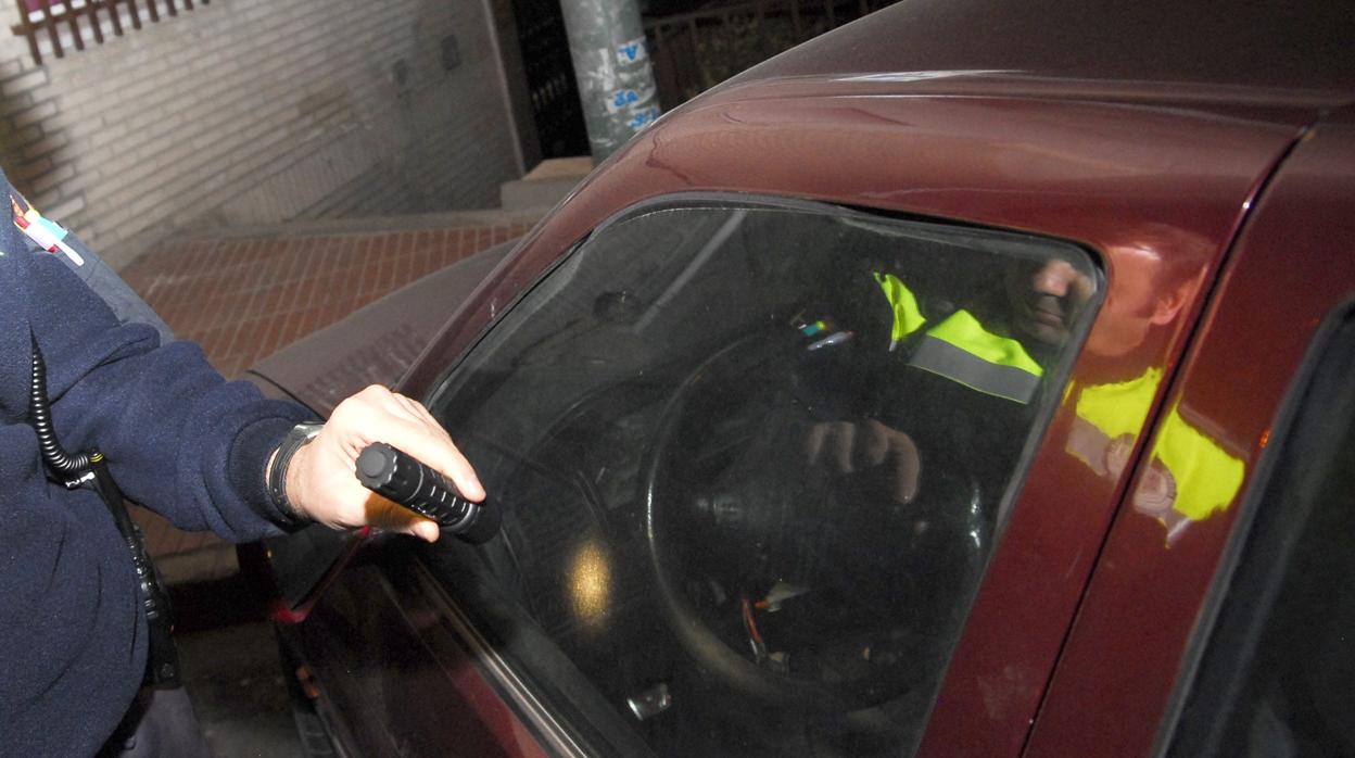 Una patrulla de policía inspecciona un coche en una imagen de archivo