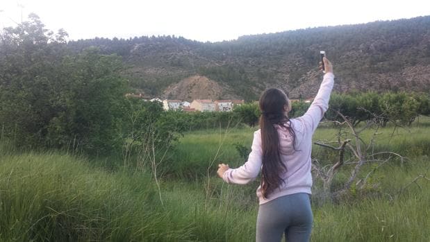 Una vecina de Las Rinconadas busca cobertura móvil a las afueras de la aldea