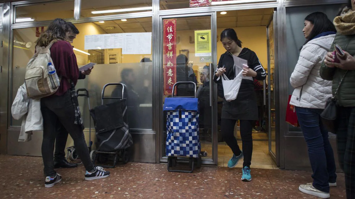Varios clientes esperan en el restaurante chino del subterráneo de la plaza de España