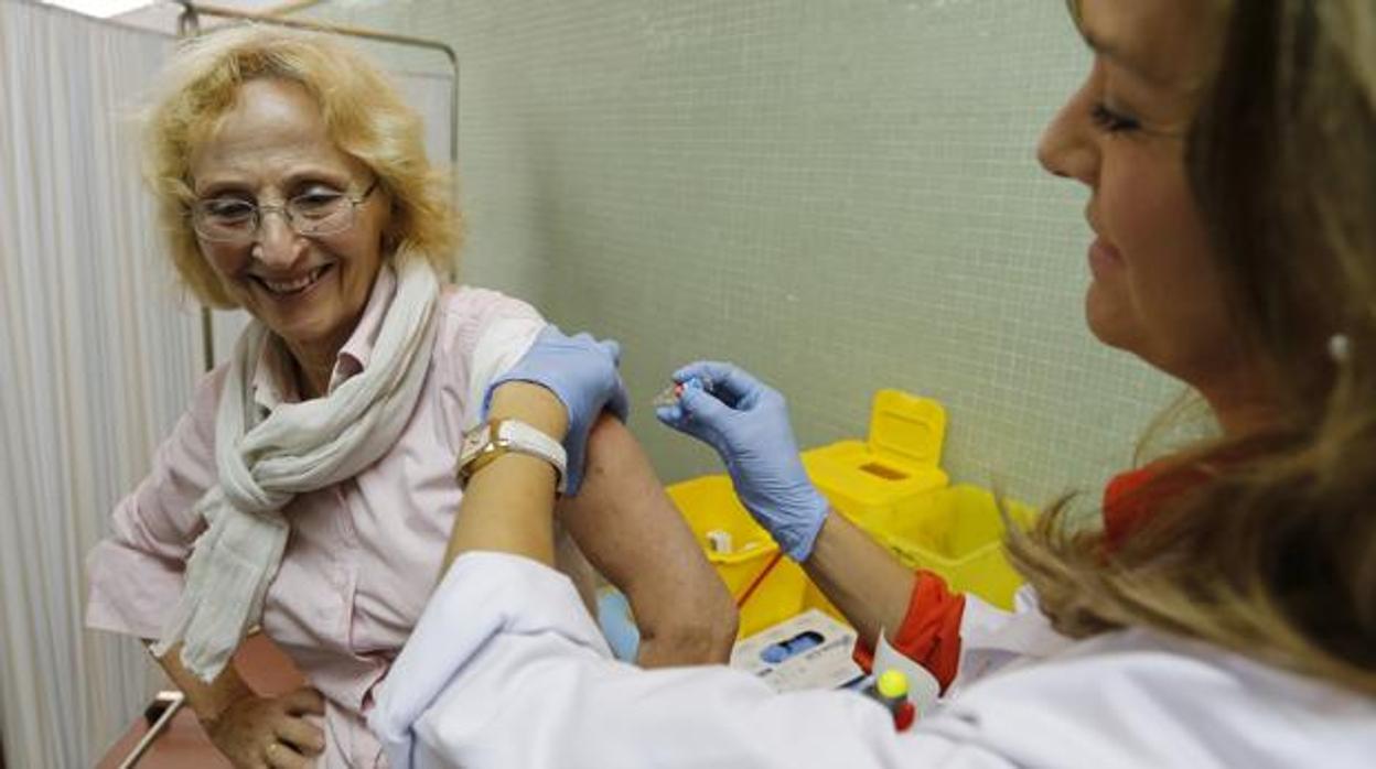 Una mujer se vacuna contra la gripe