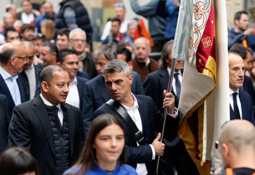 El exjugador del Valencia CF, Claudio Lopez (2d) , acompañado por el presidente del club, Anil Murthy (i), portando la bandera del club durante la marcha cívica que ha congregado a miles de aficionados el centenario de su fundación