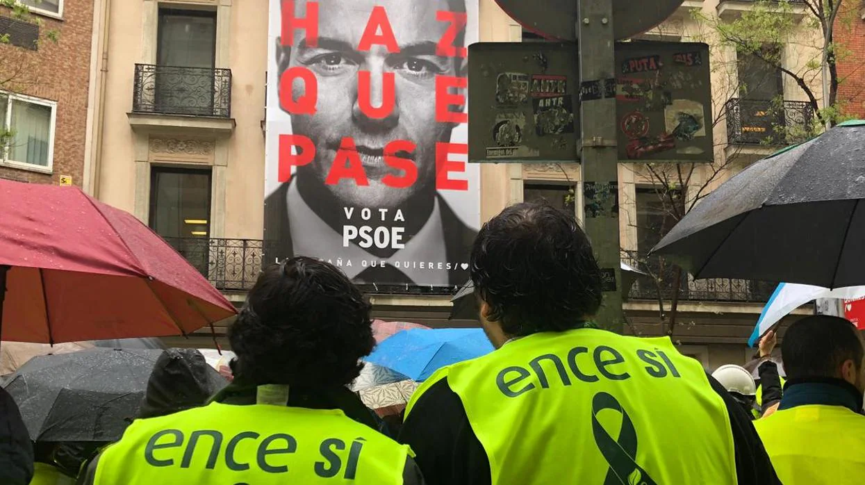 Trabajadores de Ence ante el cartel electoral de Pedro Sánchez en Ferraz