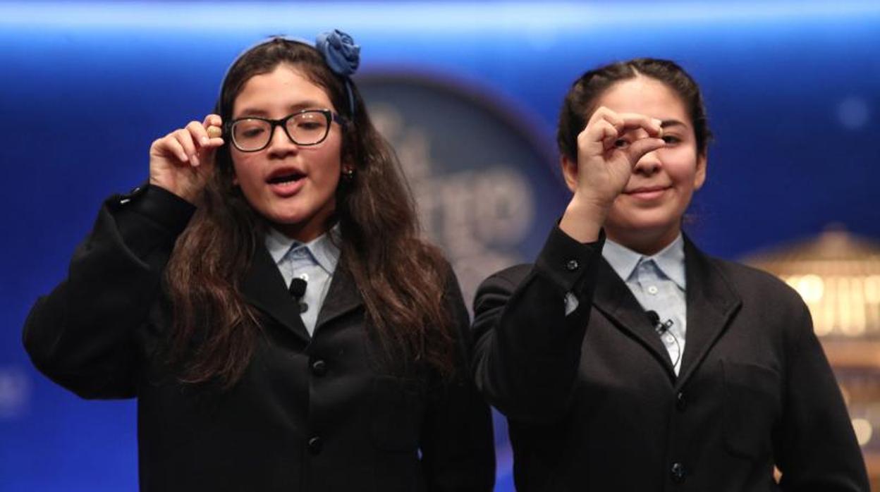 Las dos niñas de la residencia de San Ildefonso, Wendy y Nicole posan con las bolas correspondientes al Tercer Premio de la Lotería de Navidad, con el nº 00750