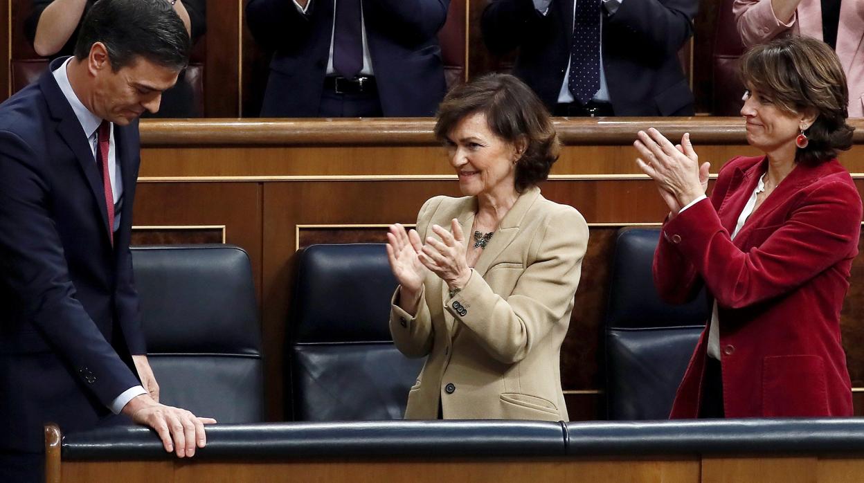 Dolores Delgado (dcha) aplaude a Pedro Sánchez junto a Carmen Calvo el pasado 7 de enero