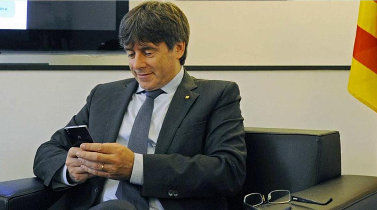 Carles Puigdemont, mirando su teléfono móvil