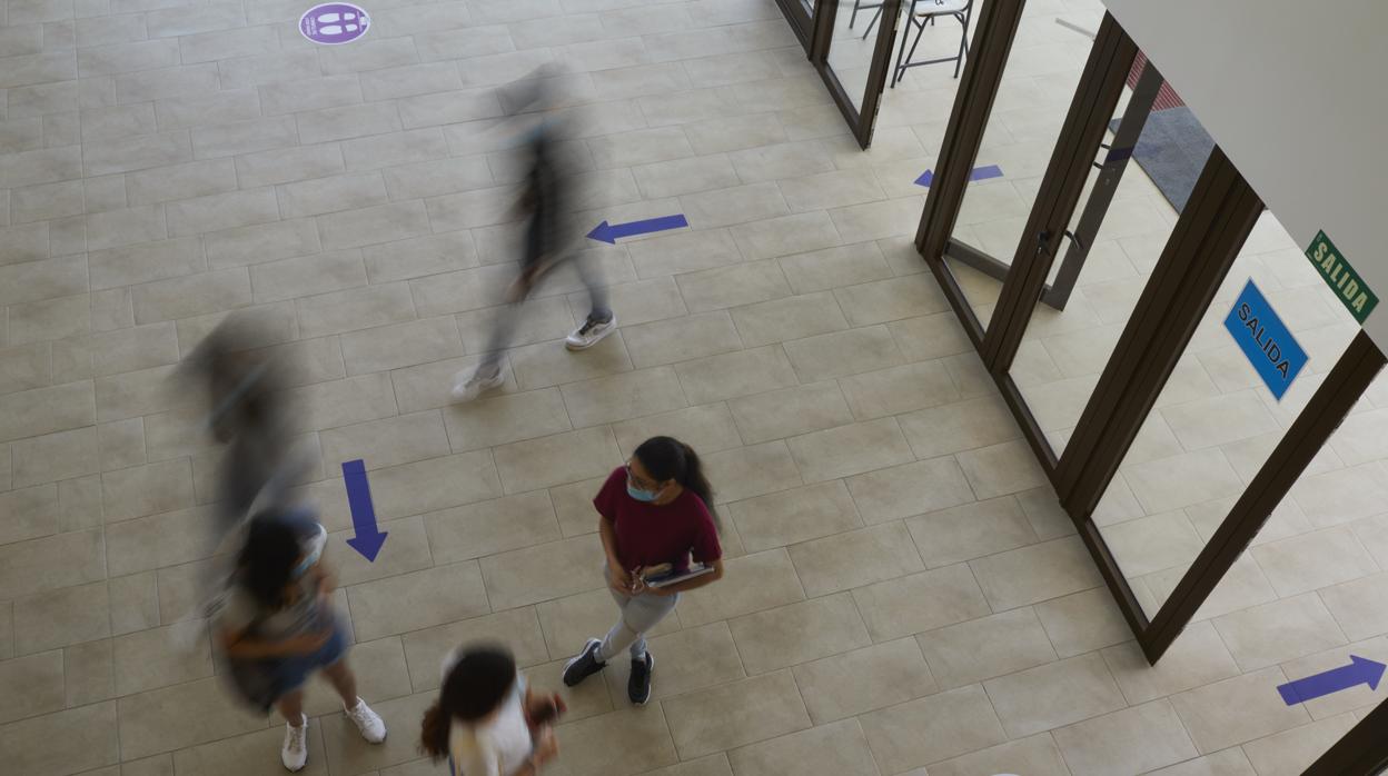 Marcas en el suelo indicando las direcciones de entrada y salida en un centro educativo madrileño