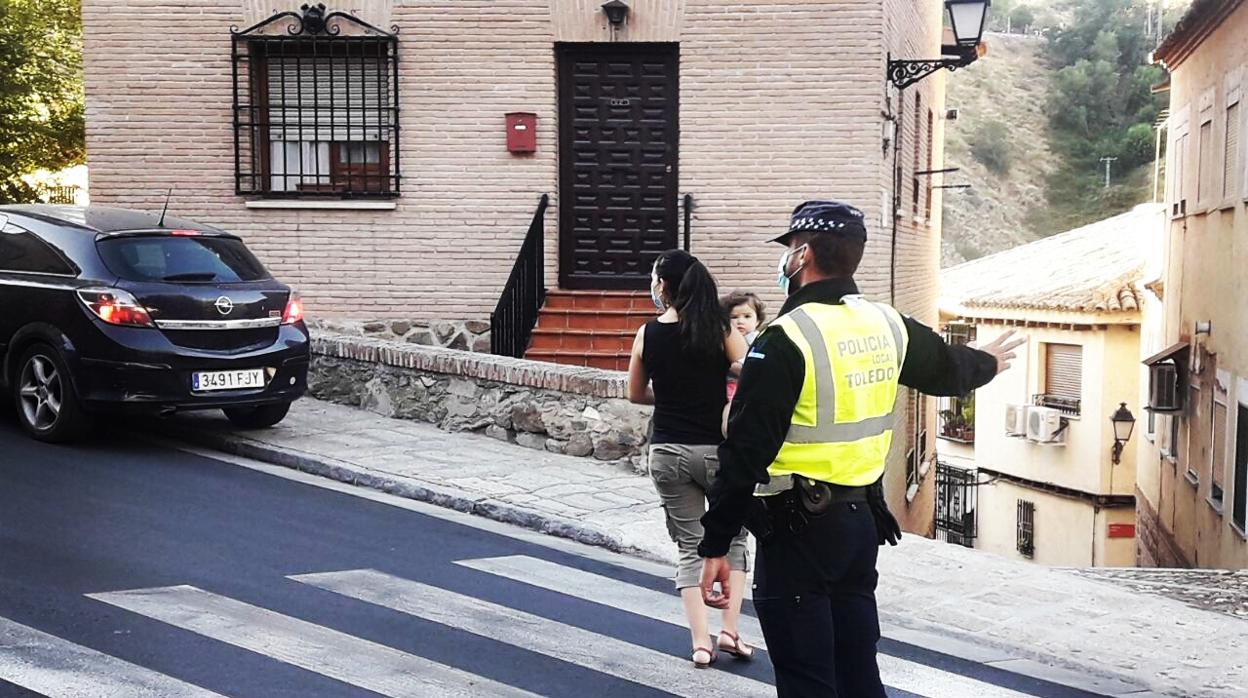 Un agente dirige el tráfiico en el Casco Histórico de Toledo