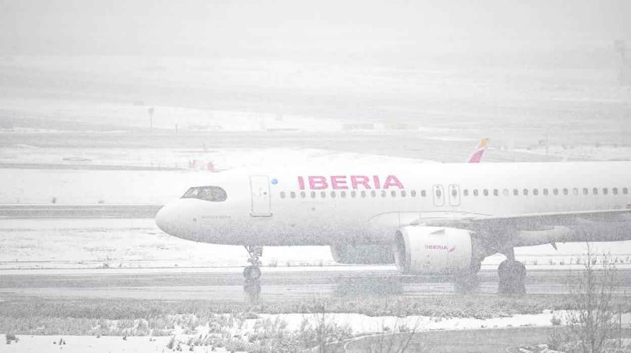 Un avión sobre una pista completamente nevada en el aeropuerto de Adolfo Suárez Madrid-Barajas