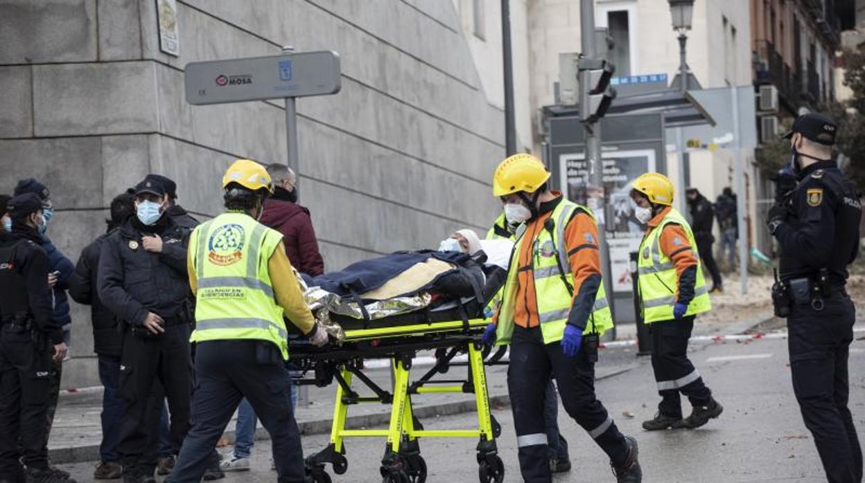 Los servicios sanitarios trasladan a uno de los heridos en la explosión de la calle de Toledo