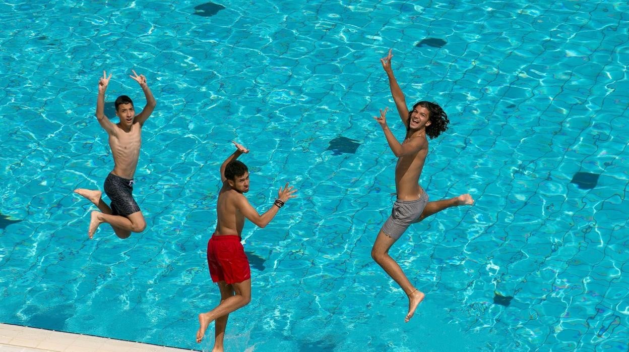 Unos jóvenes disfrutan en una piscina municipal