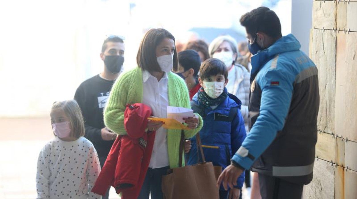 Niños y una madre esperando en la cola del 'vacunódromo' de Santiago para vacunarse