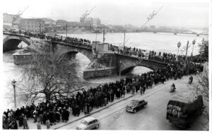 El Publico Agolpado en el pretil del Ebro y puente de piedra Contemplando la...