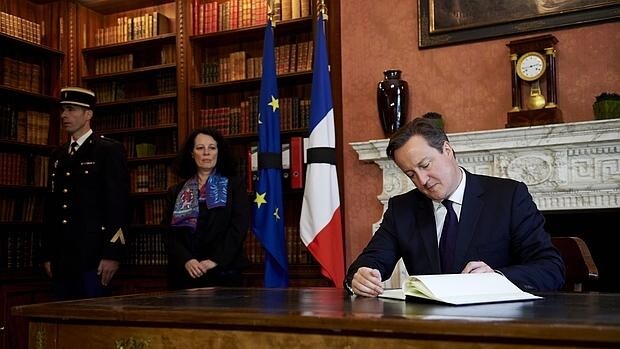 El primer ministro británico, David Cameron, firma en el libro de condolencias de la Embajada francesa en Londres