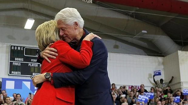 Bill y Hillary Clinton se abrazan durante un acto de campaña de la nominación demócrata en Iowa