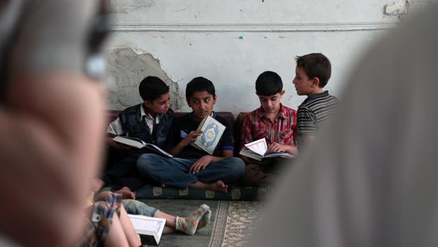 Niños musulmanes leen el Corán, su libro sagrado