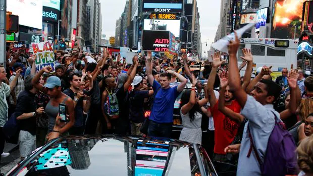 Una manifestante sujetando un cartel reinvindicativo en Times Square