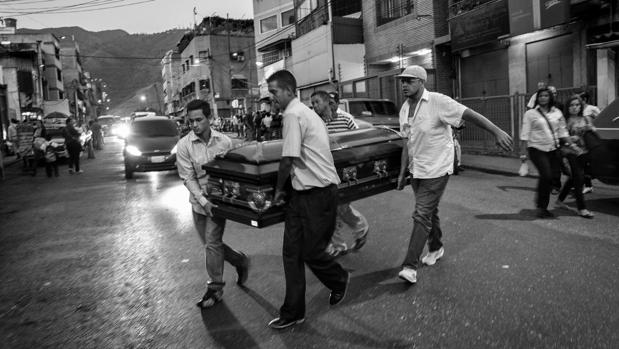 Parientes de Fredy Guerrero, un joven de 35 años torturado y asesinado por la Policía, trasladan su ataúd en el barrio de Catica (Caracas)