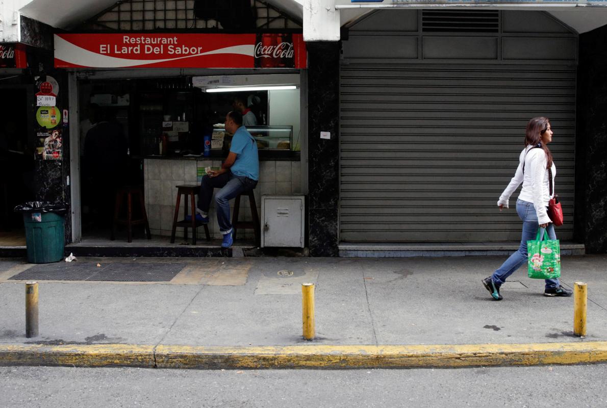 Un negocio abierto y otro cerrado, ayer en Caracas