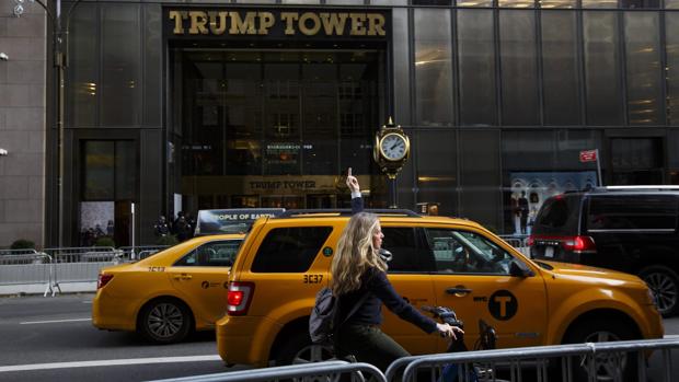 Una mujer realiza una seña obscena frente al edificio Torre Trump