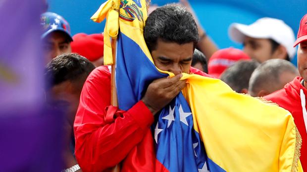 El presidente de Venezuela, Nicolás Maduro, besa la bandera del país durante el cierre de campaña