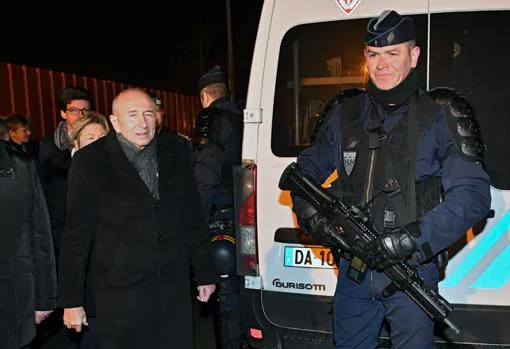 El ministro francés del Interior, Gerard Collomb, junto a un gendarme en Calais