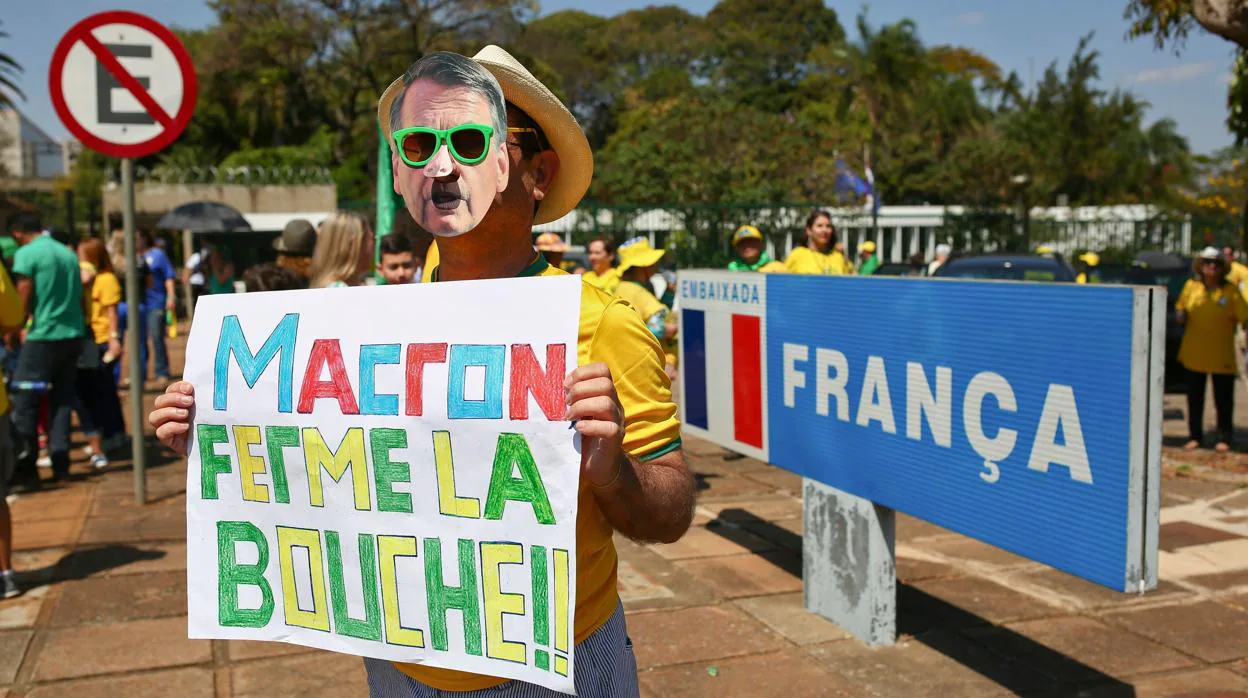Un simpatizante de Bolsonaro sostiene un cartel con la inscripción «Macron, cierra la boca» frente a la embajada francesa en Brasil este domingo