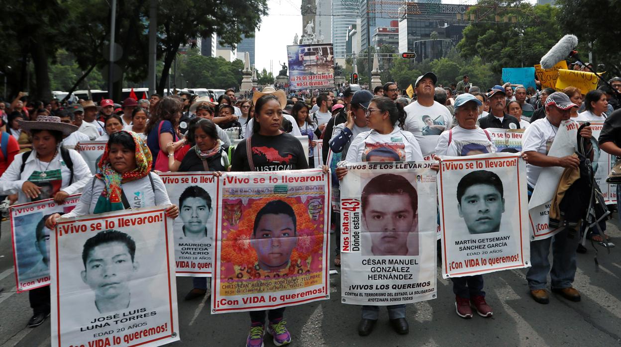 Un grupo de personas se manifiesta en 2018 con pancartas con los rostros de los desaparecidos