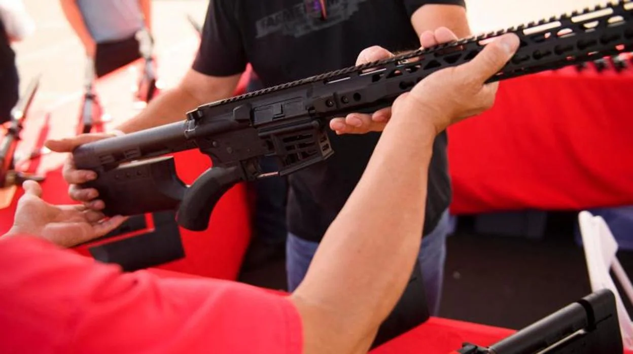 Un empleado le entrega a un cliente un rifle estilo AR-15 legal y sin características de California de TPM Arms LLC