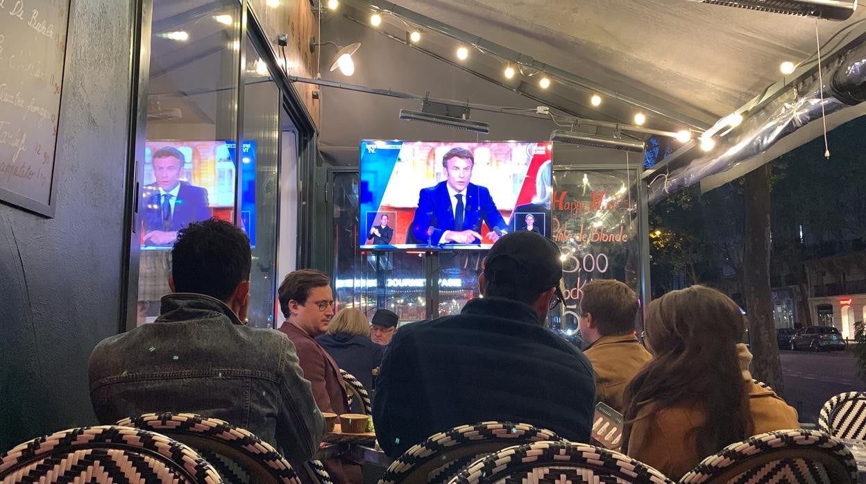 Un grupo de personas ve el debate entre Macron y Le Pen en una terraza