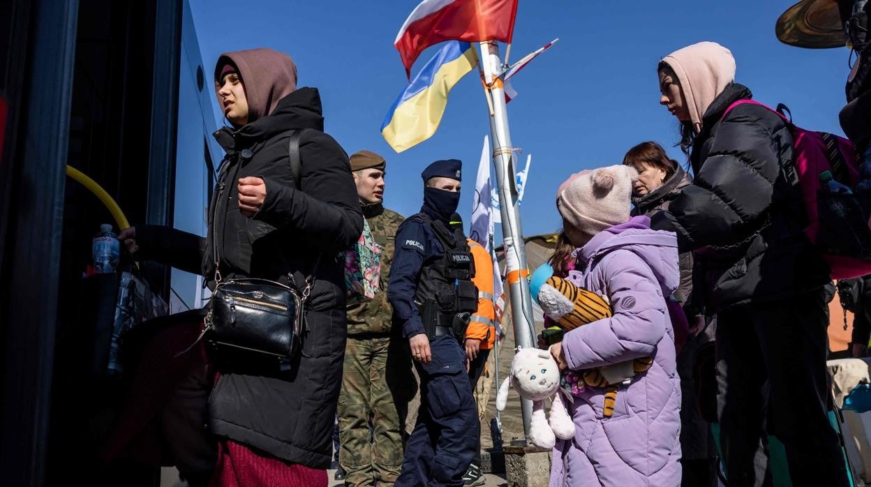 Un grupo de refugiados ucranianos se sube a un autobús en Polonia tras huir de su país