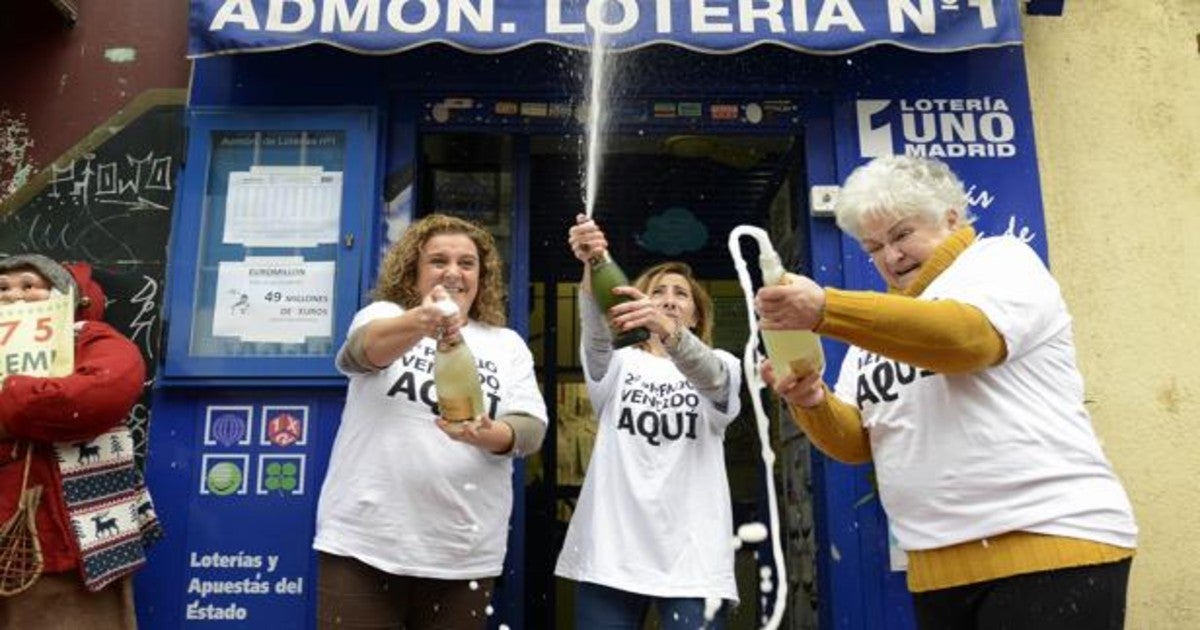 Administración de Lotería madrileña festejando su buena suerte