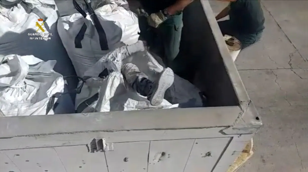 Momento del resacte del inmigrante del interior de un saco con cenizas tóxicas