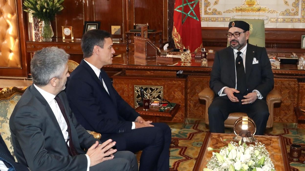 Pedro Sánchez (2i), junto al ministro del Interior, Fernando Grande-Marlaska (i), con el rey Mohamed VI