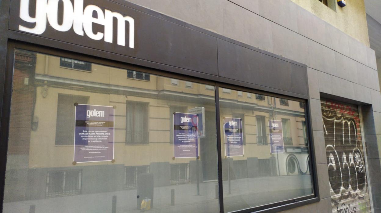 Los cines Golem de Madrid, cerrados ayer viernes. En el reflejo del escaparate, la calle Martín de los Heros, conocida como «La calle del cine», desierta