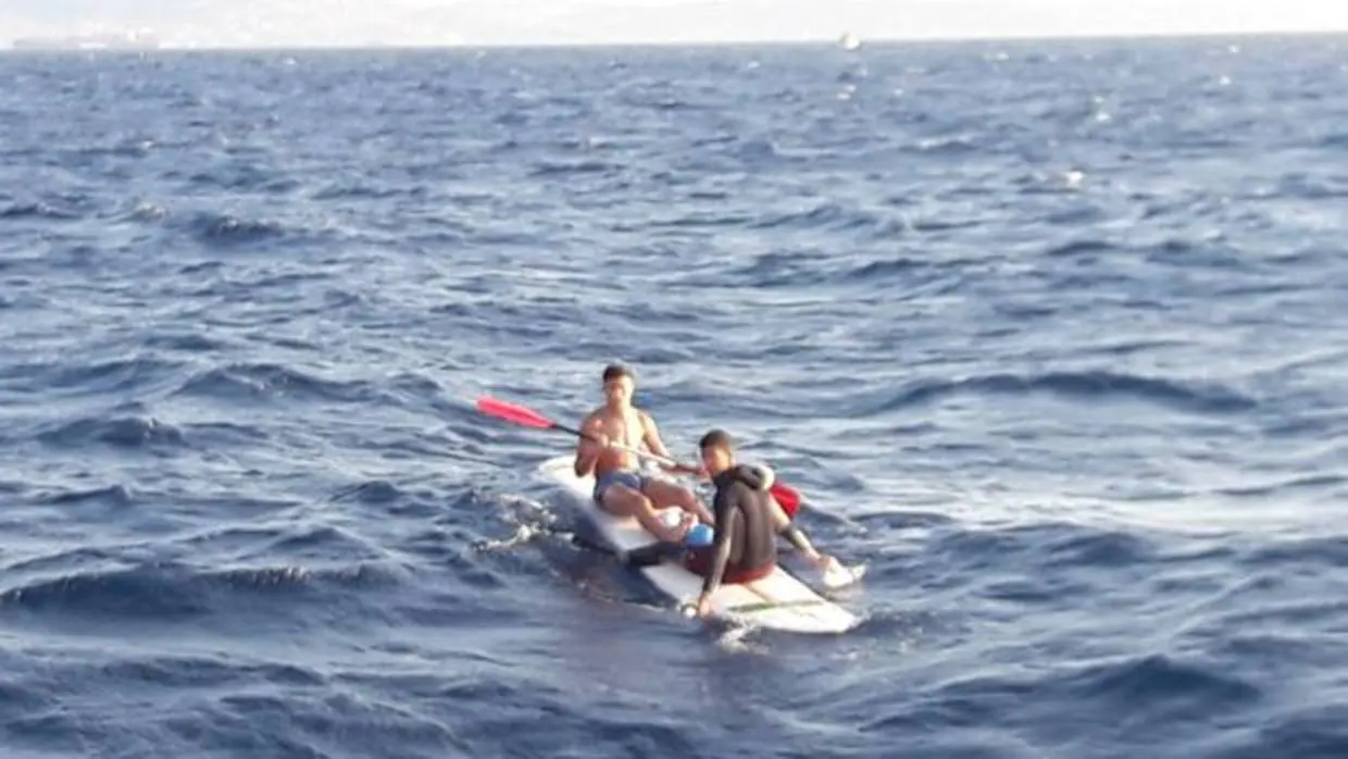 Inmigrantes en una tabla de windsurf antes de ser rescatados este miércoles frente a la costa de Tarifa.