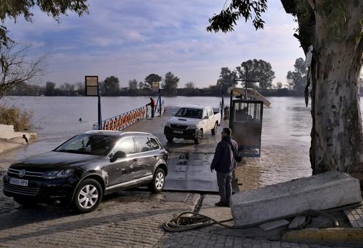 Dos vehículos desembarcan de la barcaza en uno de los trayectos que realizan a diario