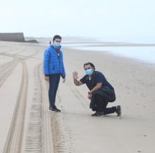 Un padre con su hijo en la playa hoy domingo.