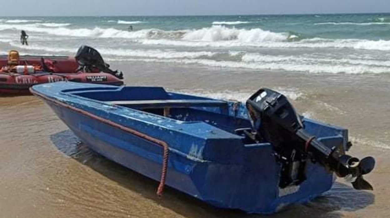 Algunos bañistas se han acercado para ver la patera en La Barrosa