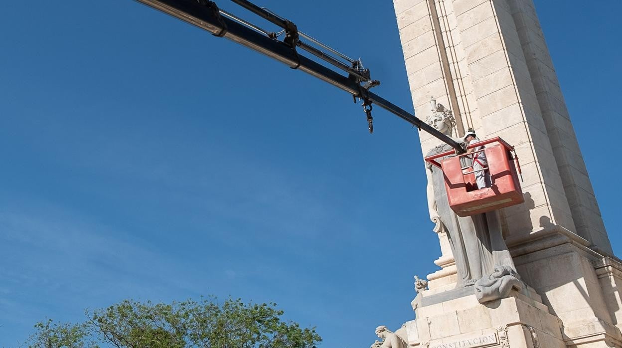 Momento en el que los operarios colocan la réplica en el monumento a Las Cortes de Cádiz