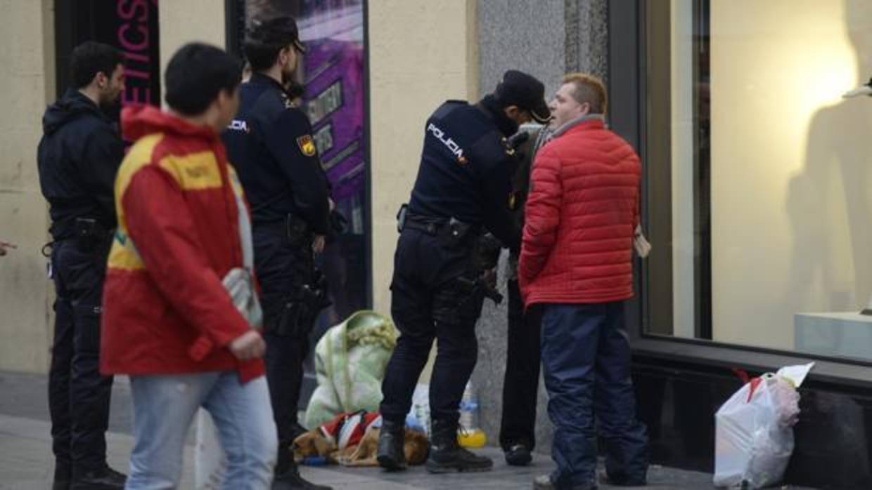 Unos agentes de Policía cachean a un sospechoso en la calle