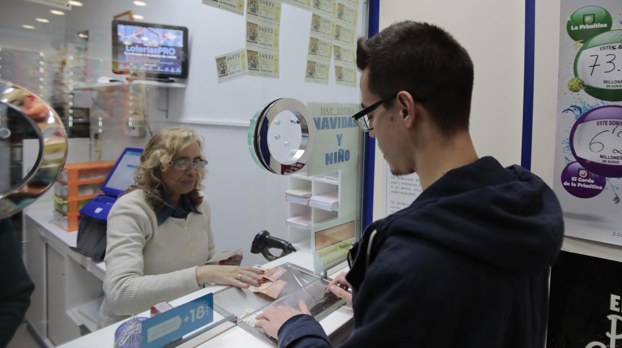 Un joven compra lotería en la administración de la calle Sagasta