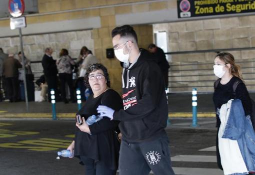 Varios pasajeros con mascarillas saliendo del aeropuerto este domingo