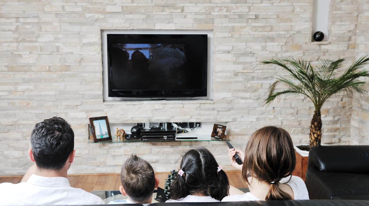 Una familia ve la tele en casa